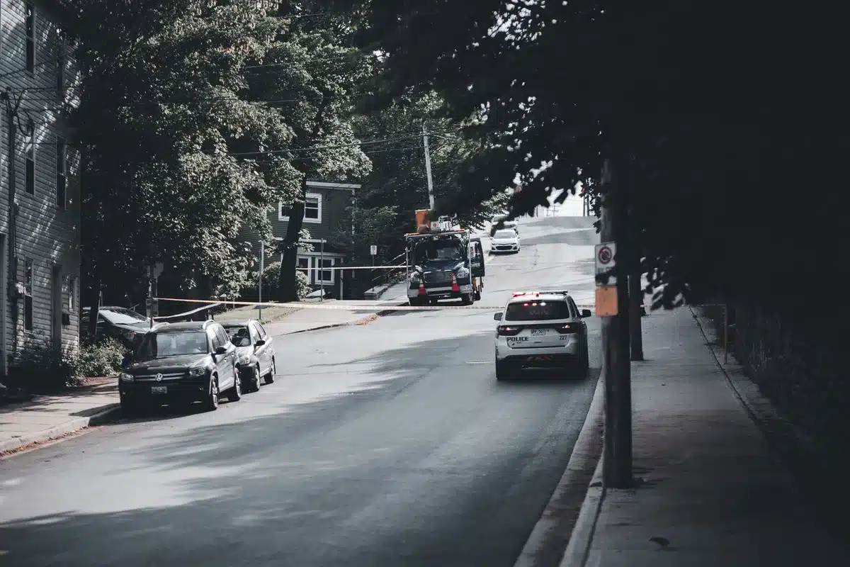 Multiple police vehicles and officers responding to an incident near a courthouse building.