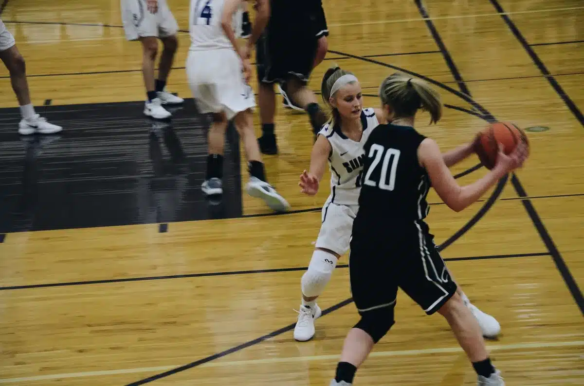 Caitlin Clark playing basketball in front of a packed arena crowd
