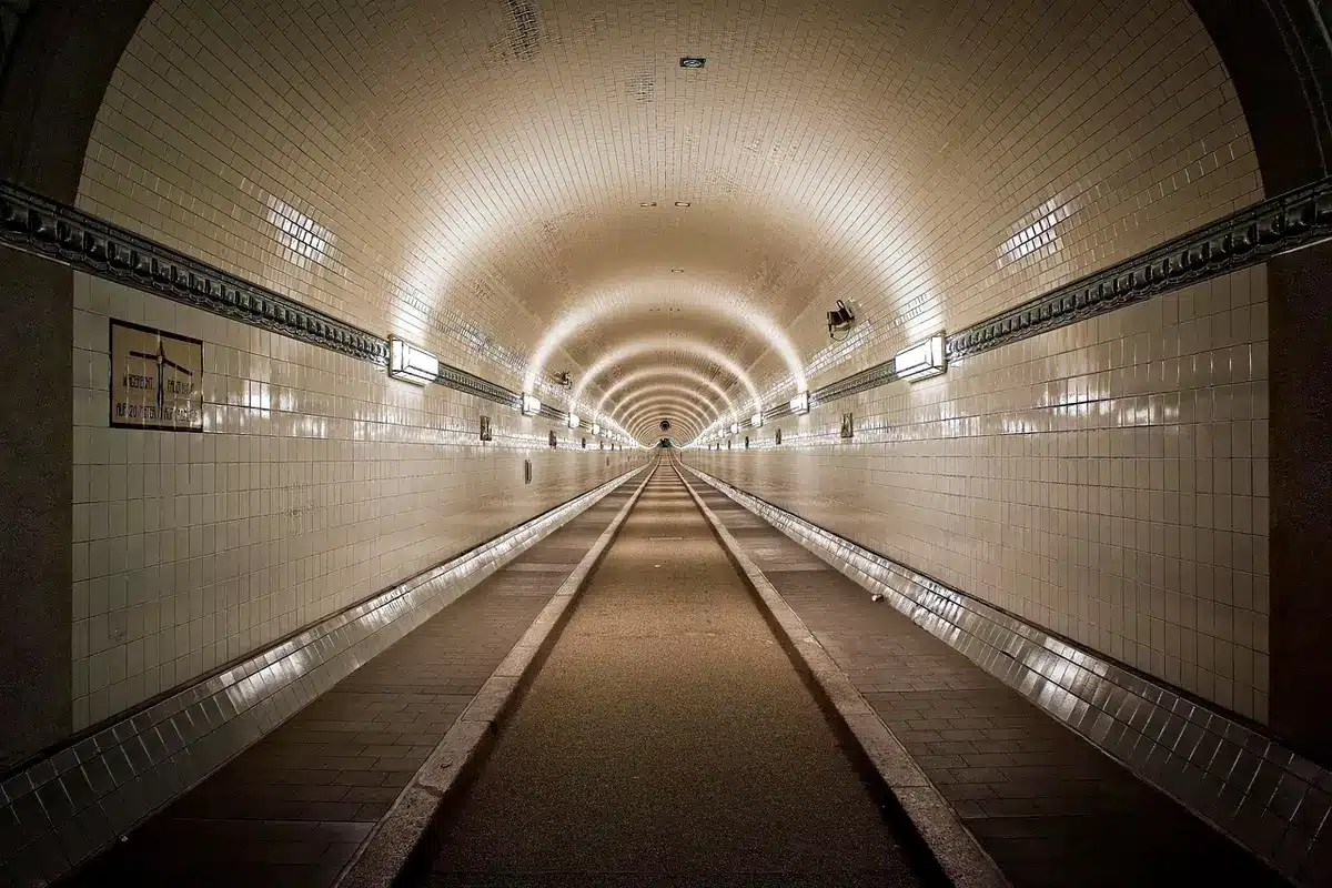 Endless corridor with repeating wallpaper and fluorescent lights