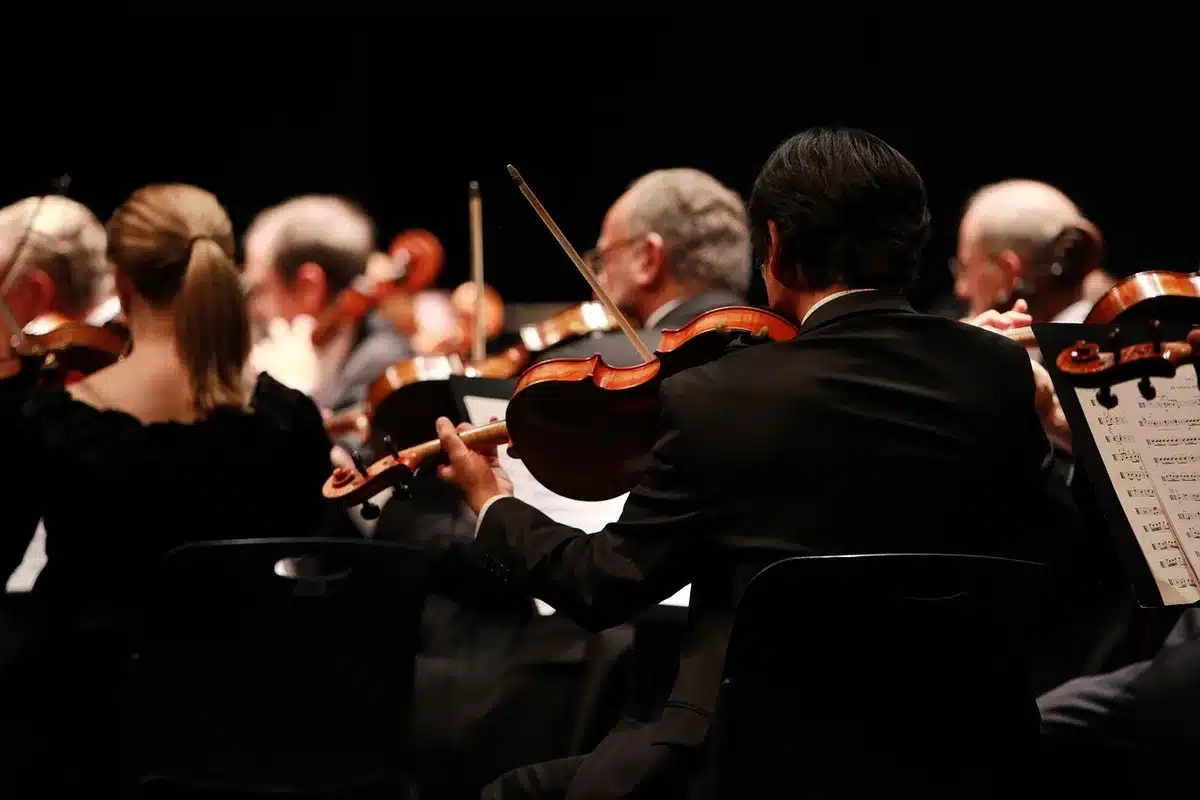 Orchestral string section on a concert stage evoking cinematic arrangement