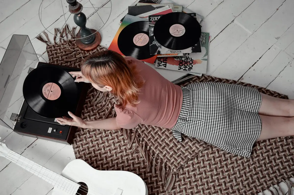 Record player and phone playlist laid out for an evening at home