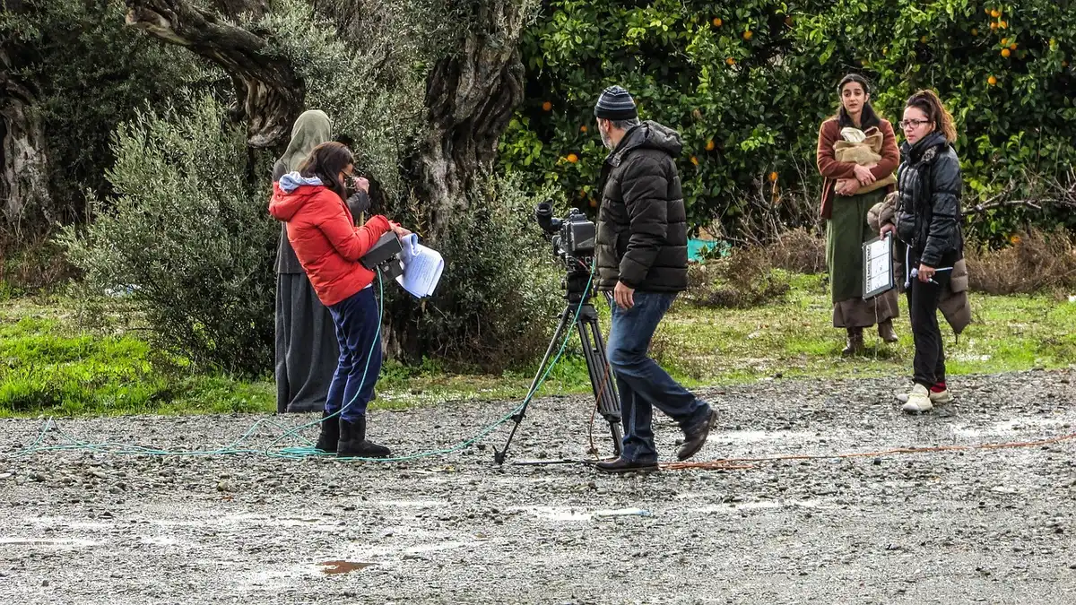 Film crew working on set illustrating production labor costs