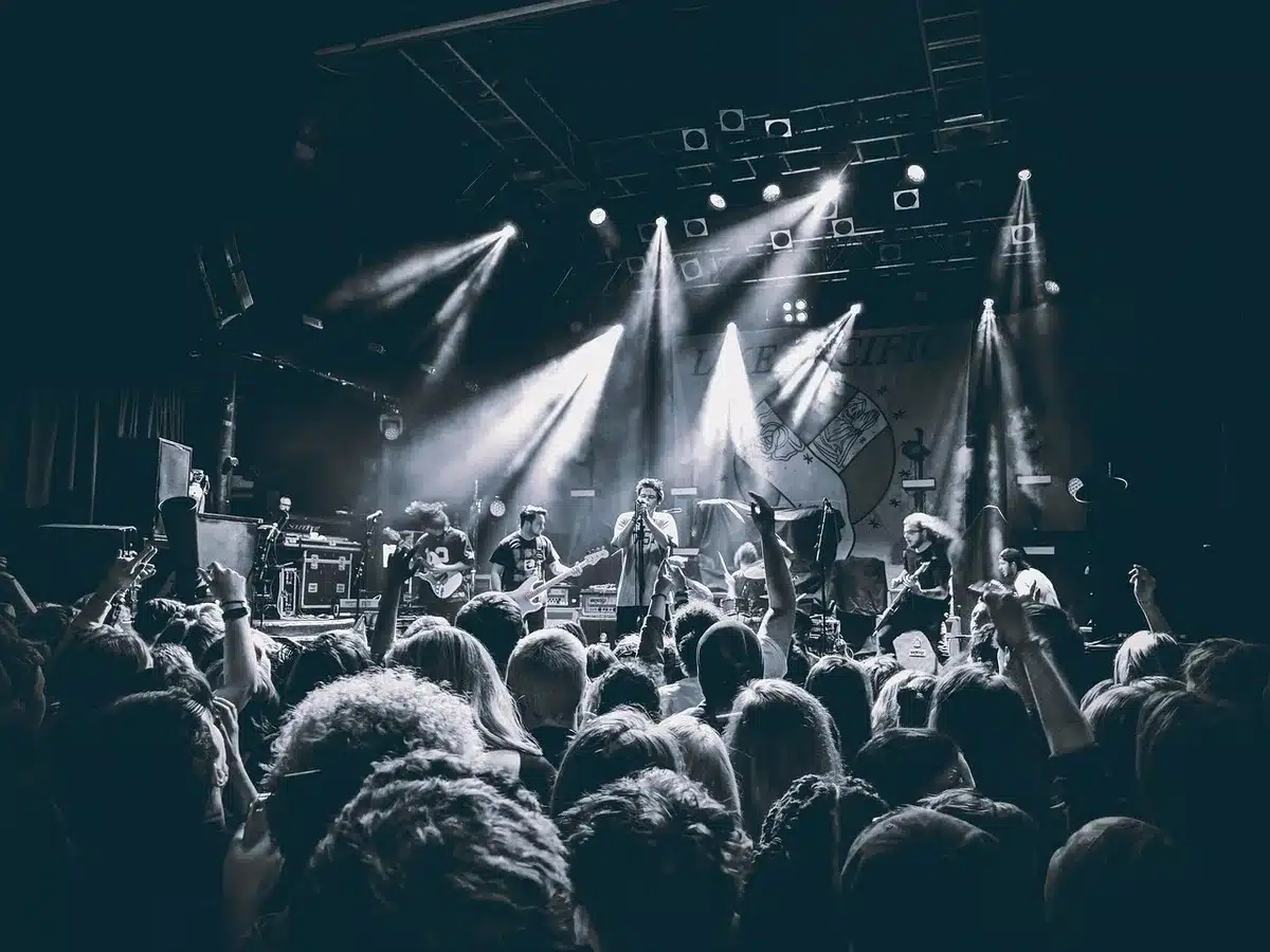 Musiker auf der Bühne mit Gitarre und Mikrofon während eines Pop-Punk-Konzerts