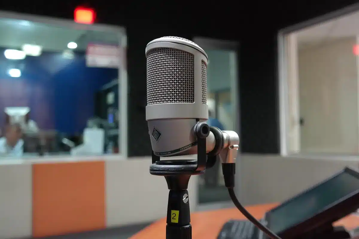 A vintage microphone and handwritten lyrics in a small studio