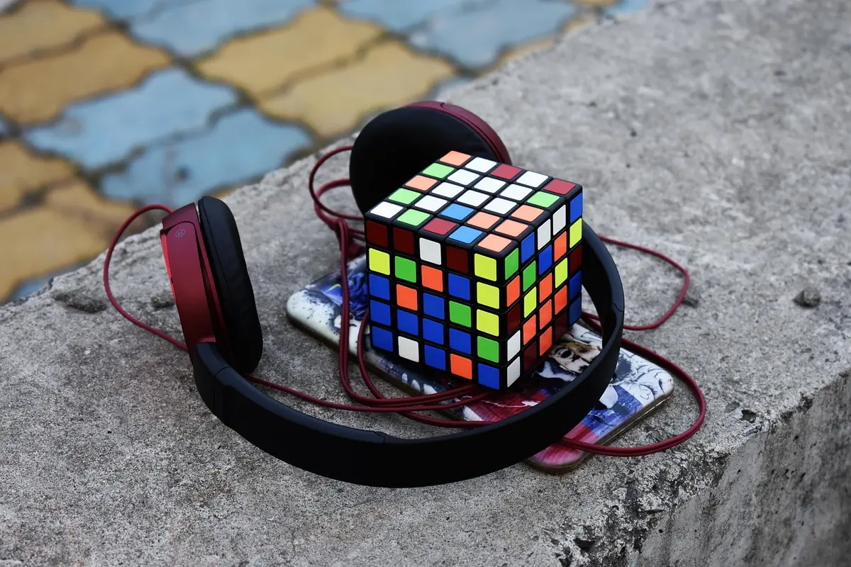 Headphones resting on a table beside a minimalist room bathed in soft light