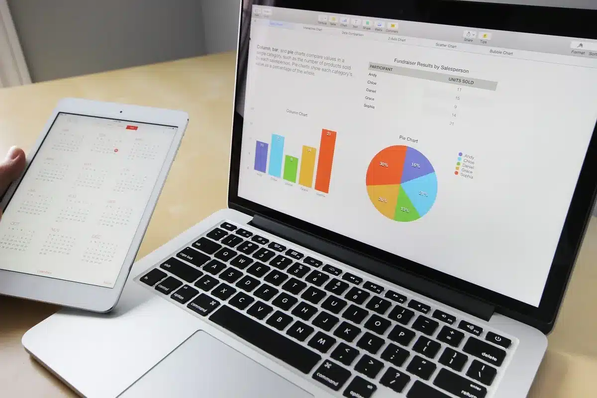 Printed 401(k) statements and a laptop showing a spreadsheet of balances