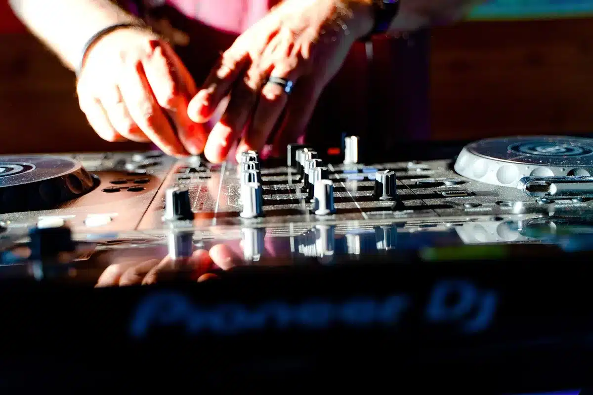 Street DJ passing a mixtape to a fan on the street, showing grassroots music distribution