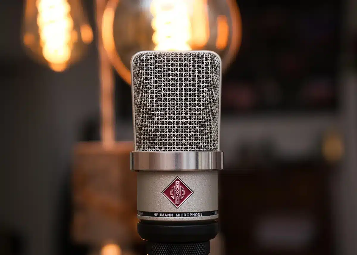 Retro recording studio with cassette boxes and a microphone representing 1990s hits