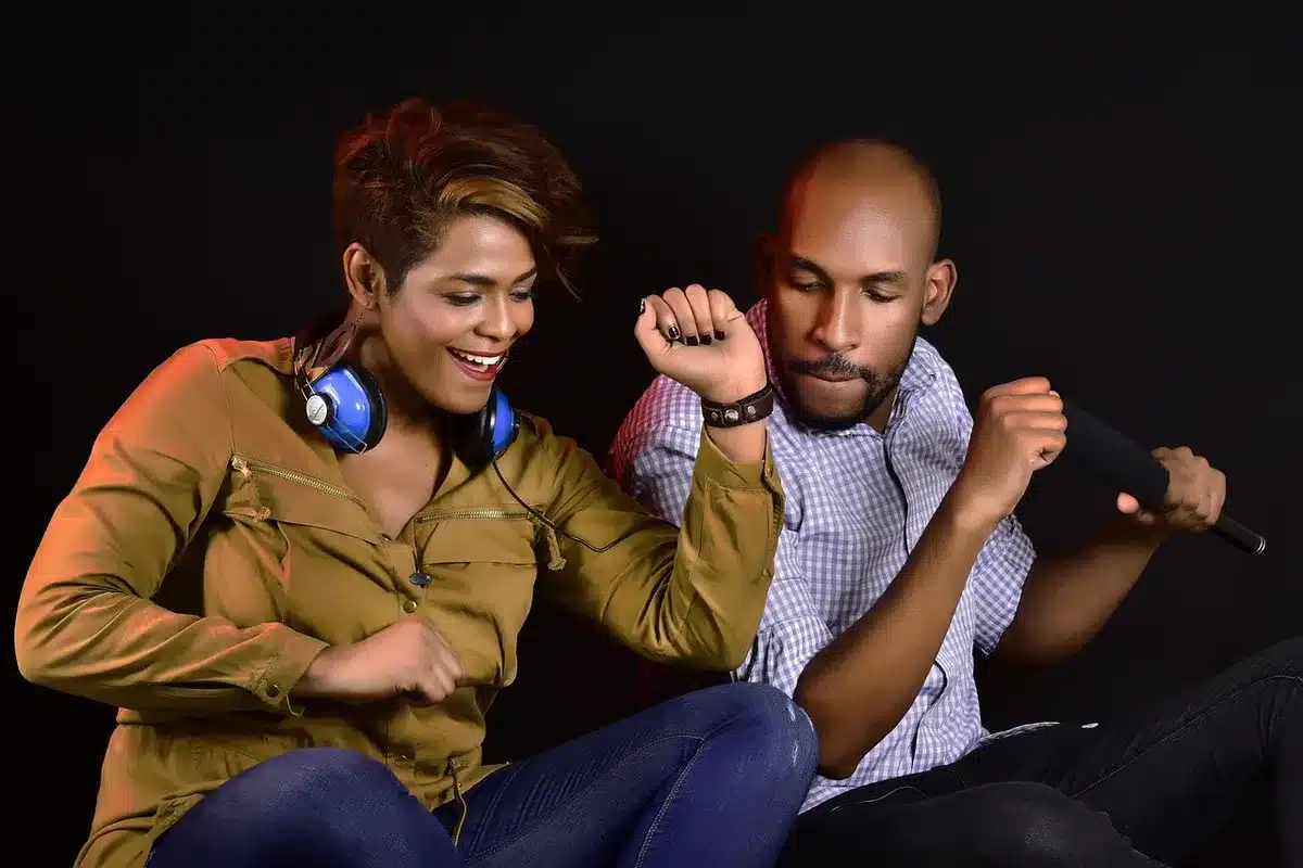 Two people enjoying music together in a dimly lit setting