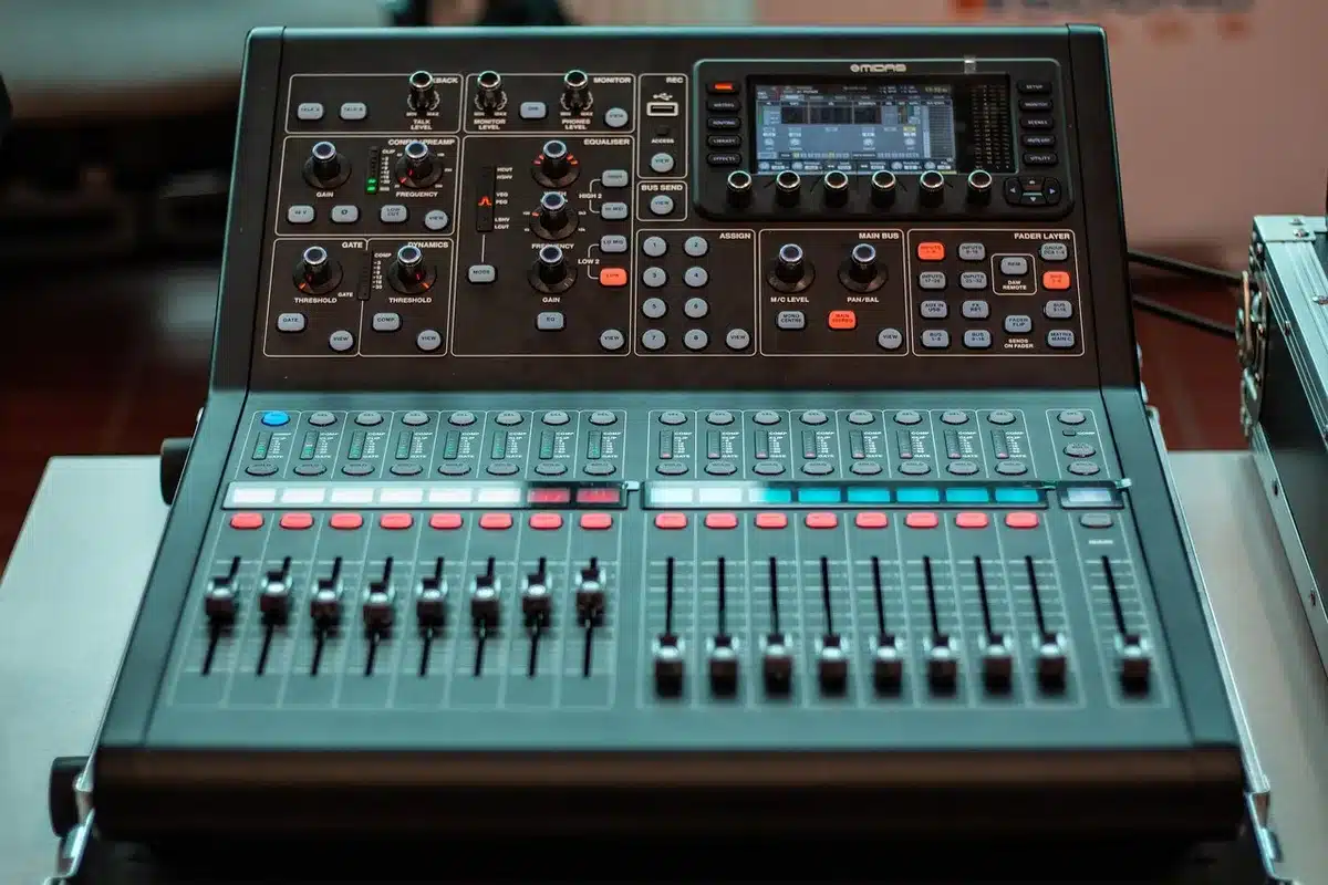Engineer at a vintage mixing console with tape machines and overdub tracks