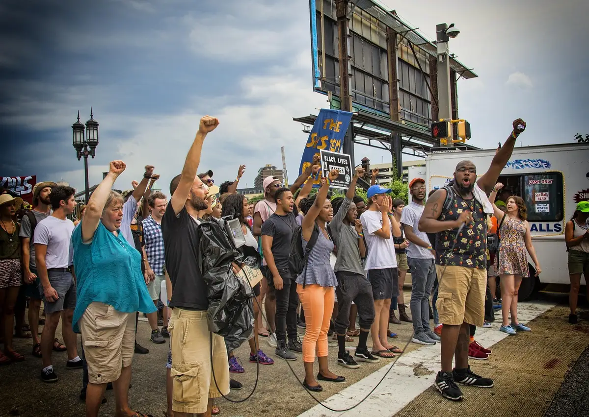 Group of activists using phones with protest signs and hashtag graphics