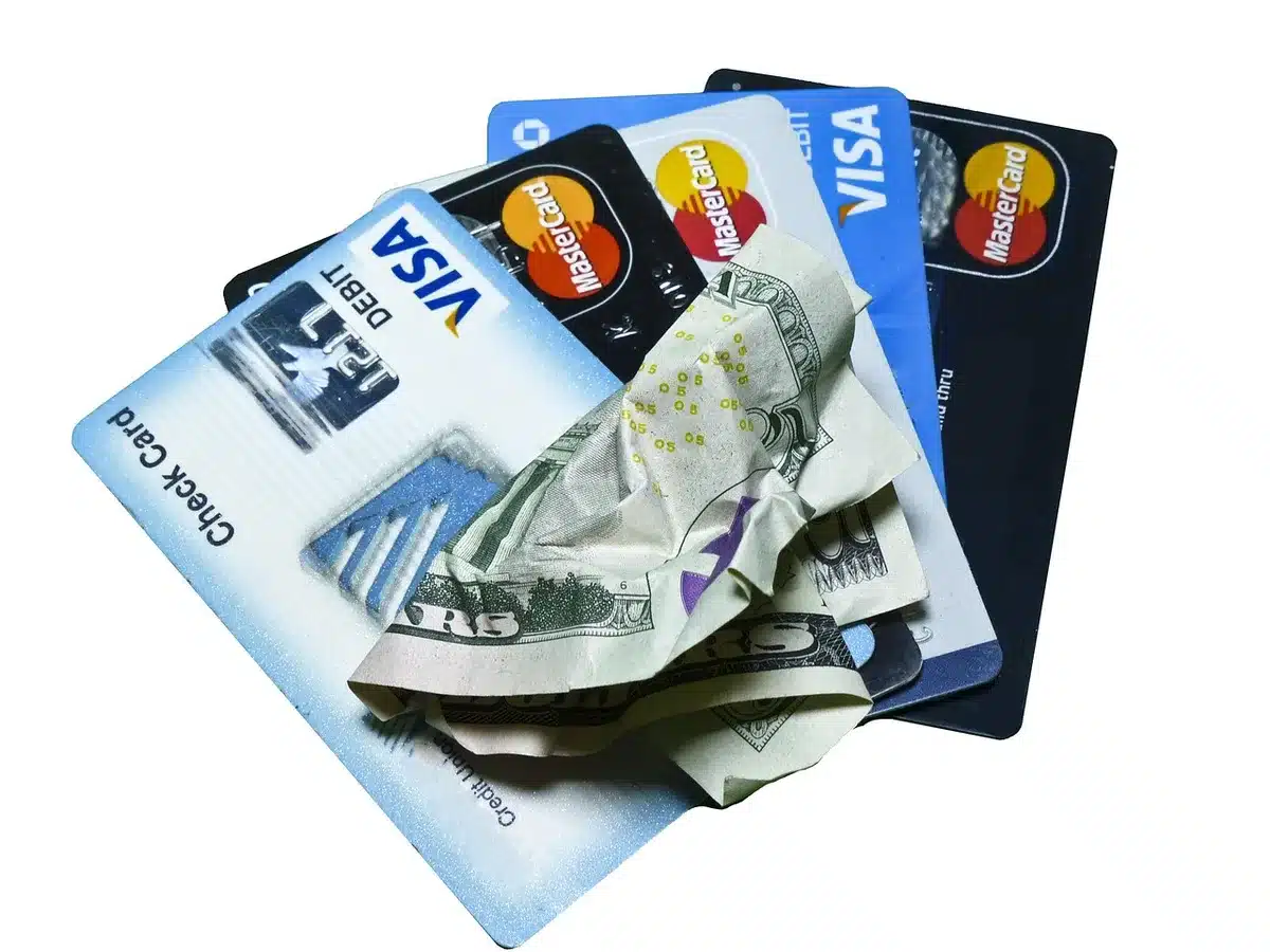 Stack of unpaid bills and credit cards illustrating household debt