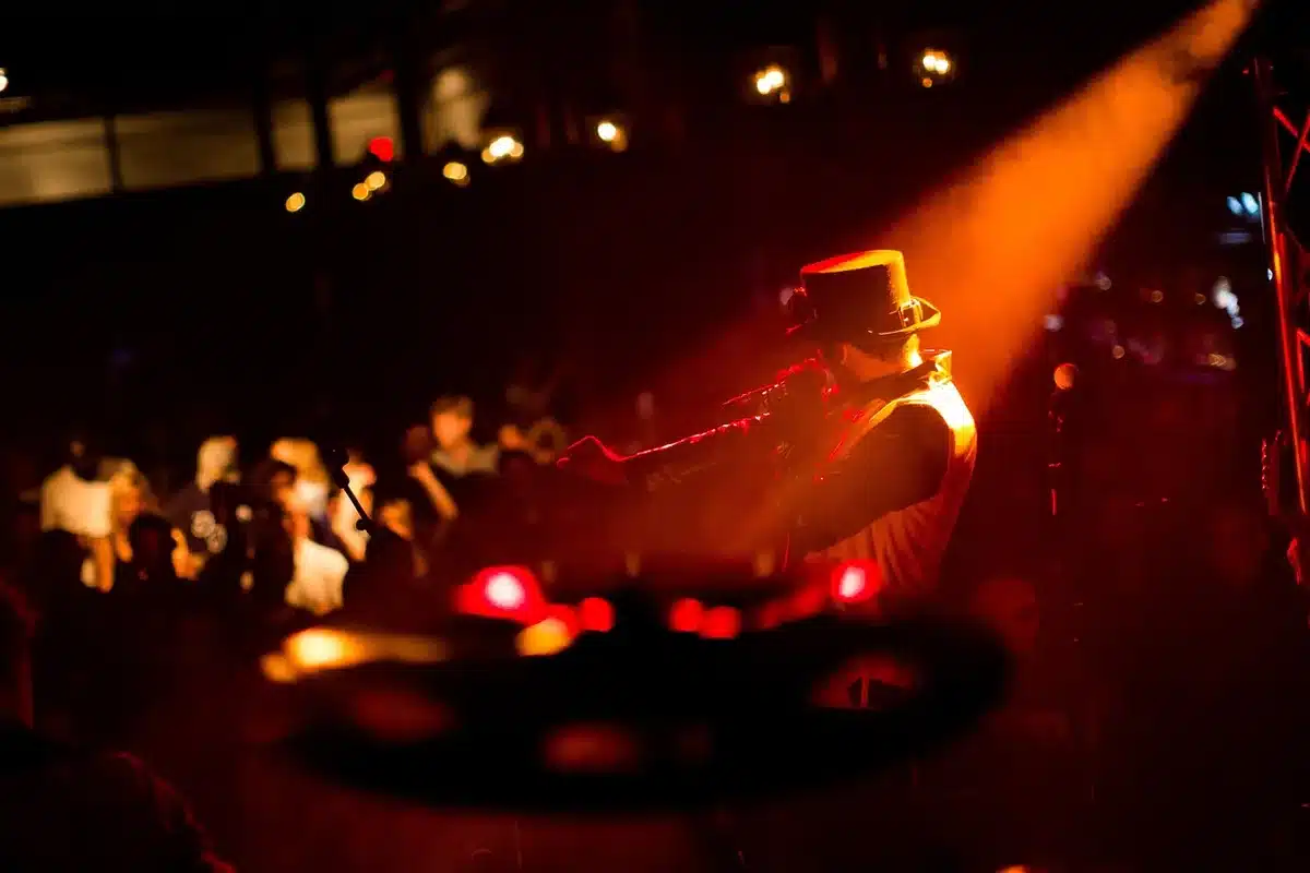 Energetic live stage with dramatic lighting evoking sprawling prog compositions