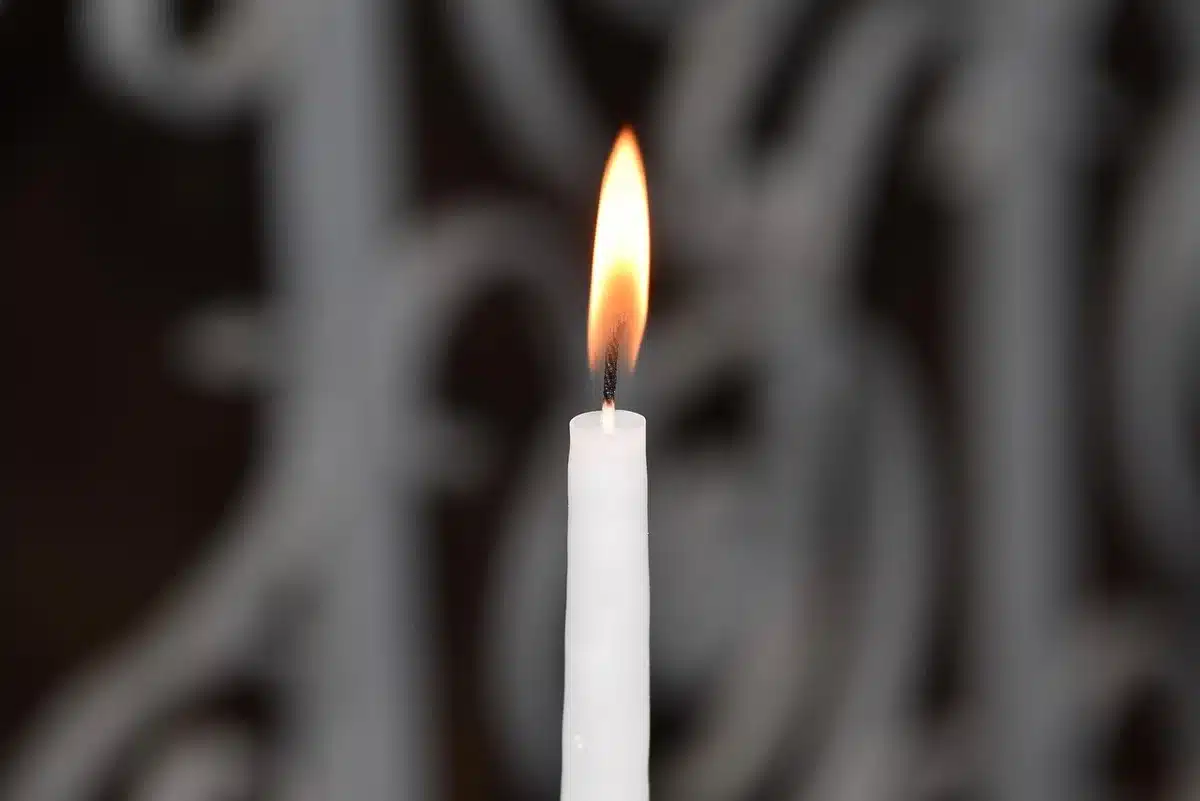 Community vigil with candles and posters at night