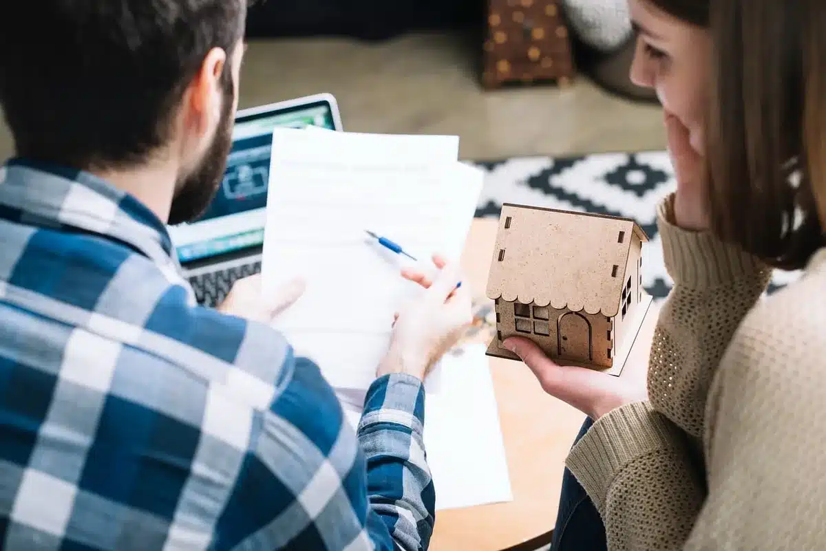 Hands pushing contract papers across a table during negotiations