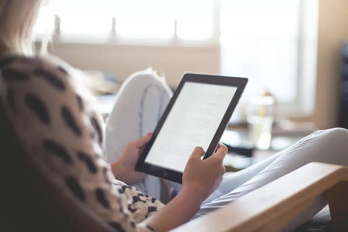 Compact e-reader device next to everyday items, demonstrating its portability and small form factor