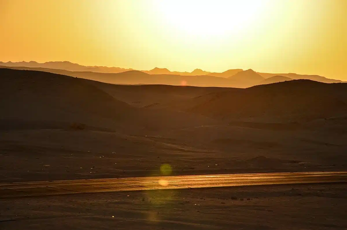 Festival attendees in intense desert heat and sunlight, highlighting environmental hazards
