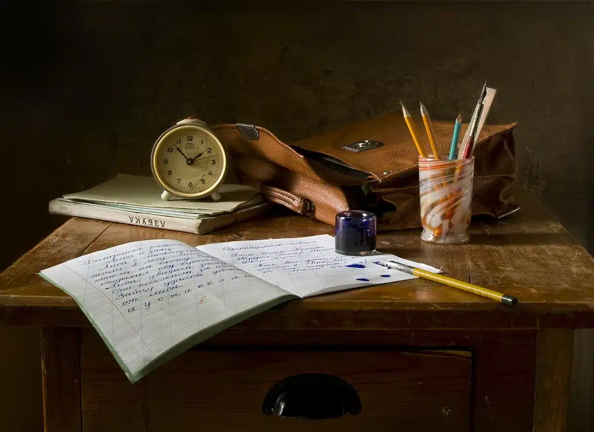 Hands arranging small cartoon-style anvil and rocket on a lawyer's desk with legal pad