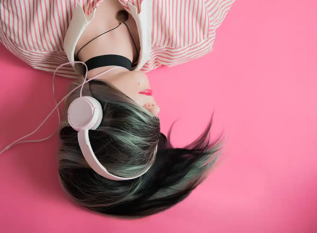 Person with headphones sitting quietly, focusing on music
