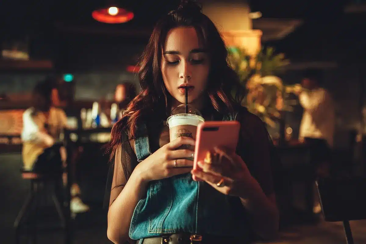 Smartphone showing a playlist on a couch armrest