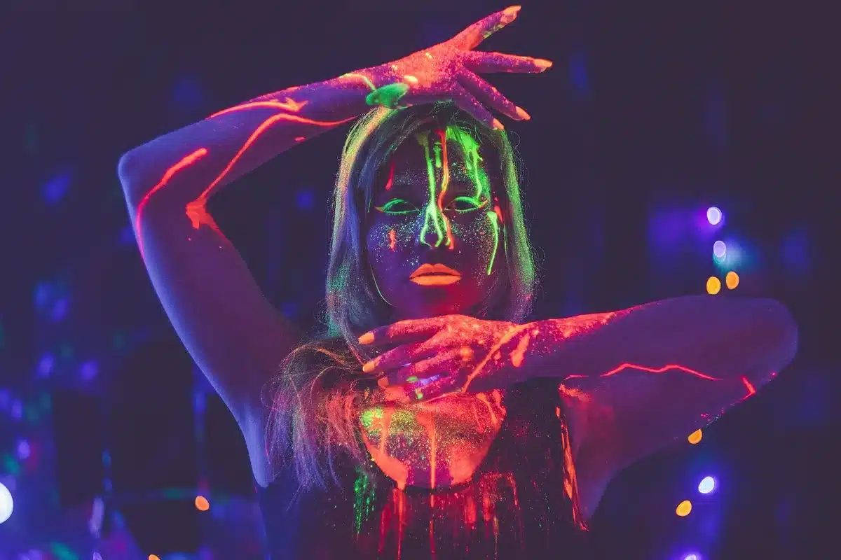 Bright neon-lit synths and arcade-style visuals evoking maximalist electronic textures