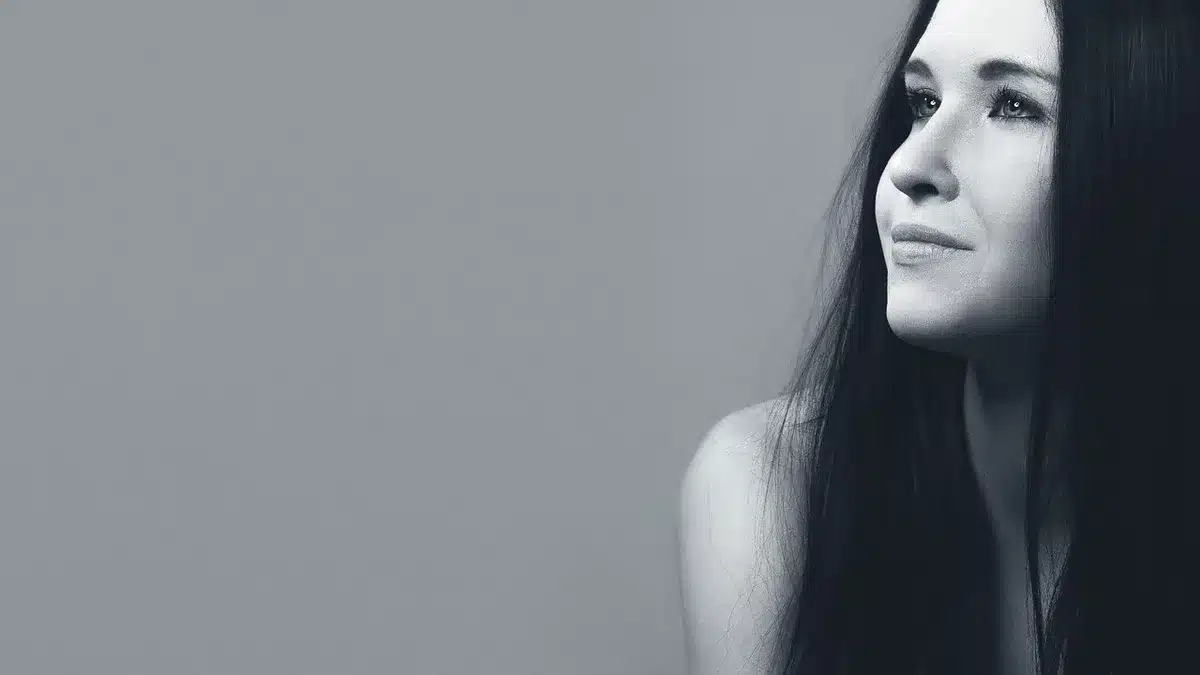 Profile of a composed woman in neutral lighting, expression restrained