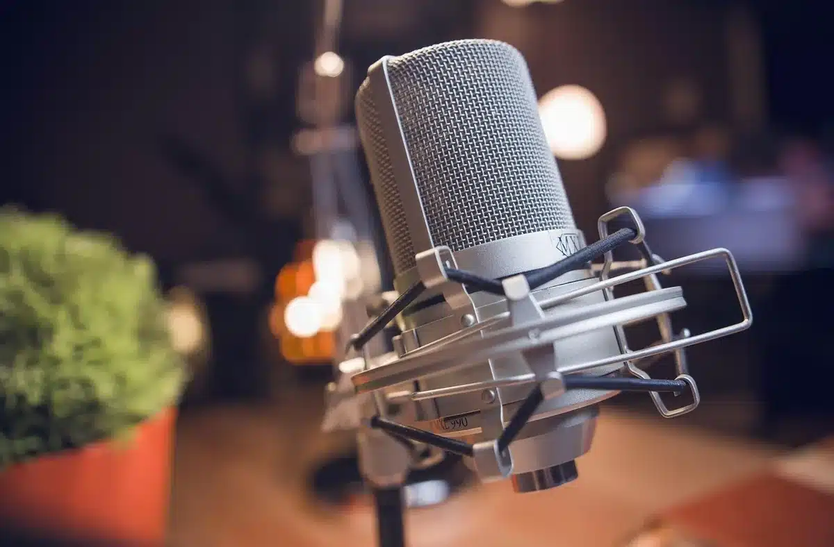 Notebook and studio microphone suggesting songwriting and sampling