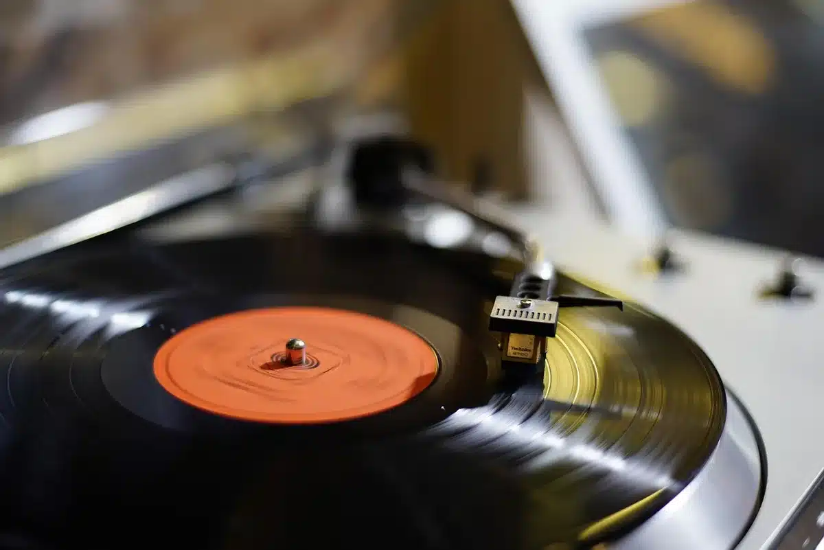 Close-up of vinyl record and headphones with emo playlist vibes