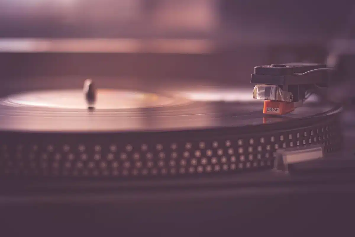 Person silhouette listening to music with warm indoor lighting