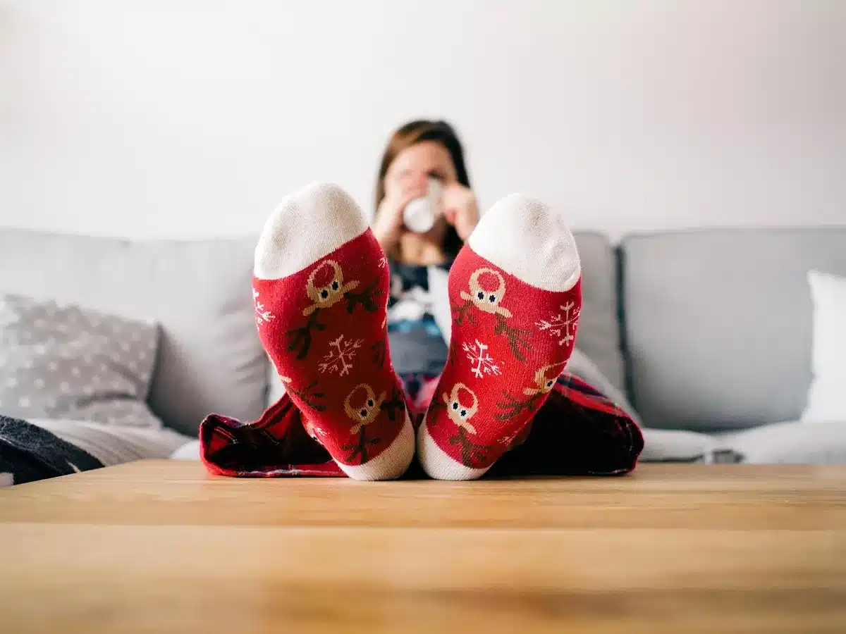 Person reading in a cozy chair with a small timer on the table