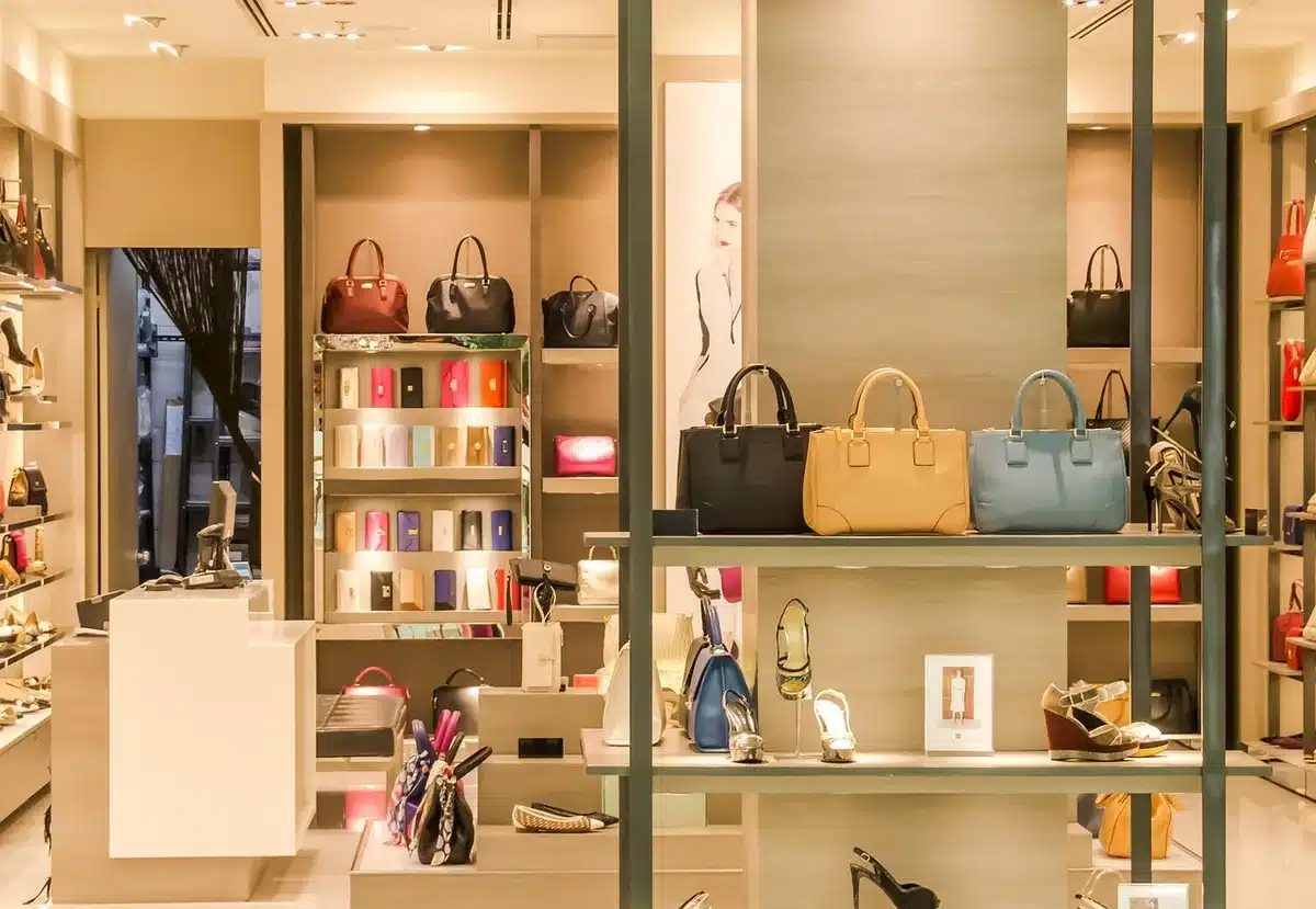 A vintage 1960s fashion boutique interior with clothing racks and displays