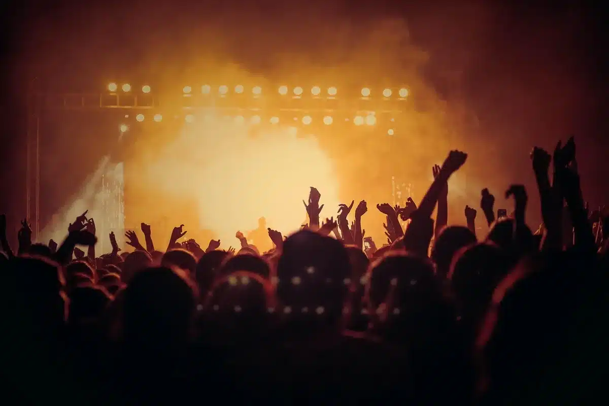 Female guitarist on stage delivering aggressive, energetic performance