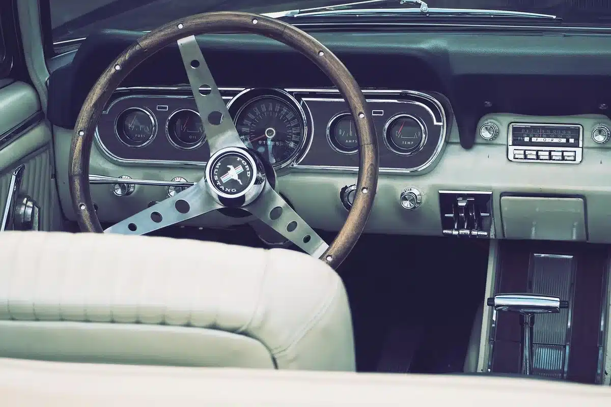 Car dashboard with radio showing a DJ host segment playing