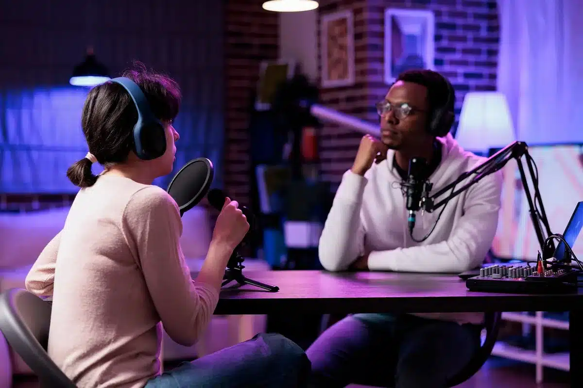 A podcast recording setup with host and guest in conversation at microphones