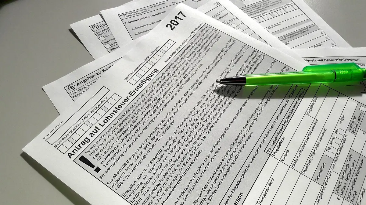 Close-up of hands sorting bills and childcare invoices