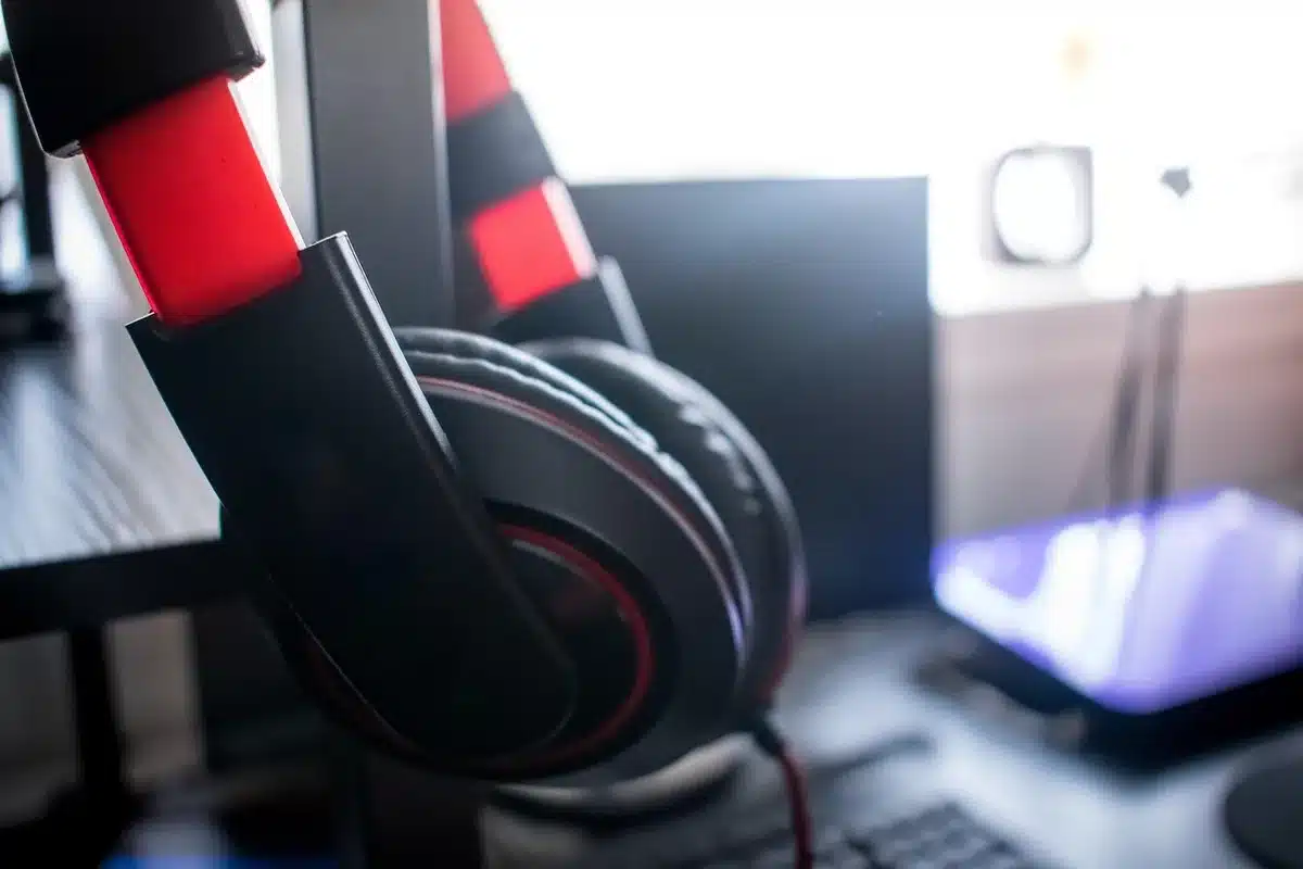 Headphones beside a laptop showing music analytics