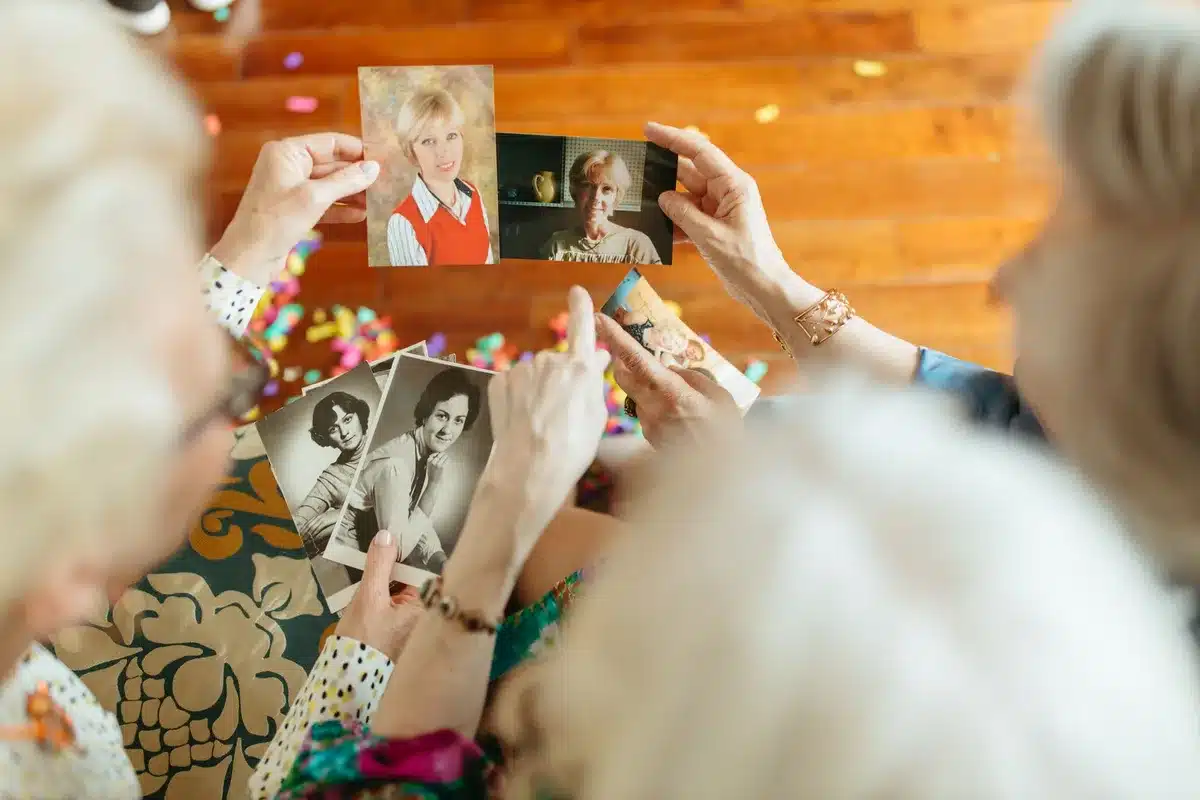 Hands holding a worn photograph suggesting memory and reconciliation
