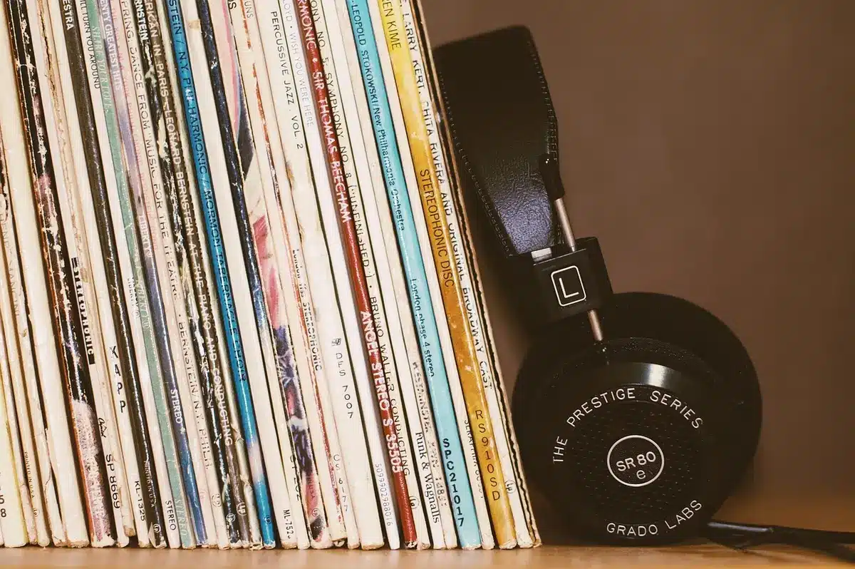 Headphones next to sheet music and soft lighting suggesting intimate electronic textures