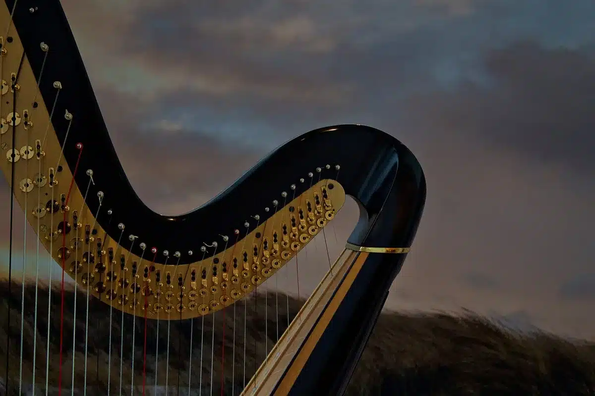 Harp with orchestral sheet music, evoking baroque storytelling