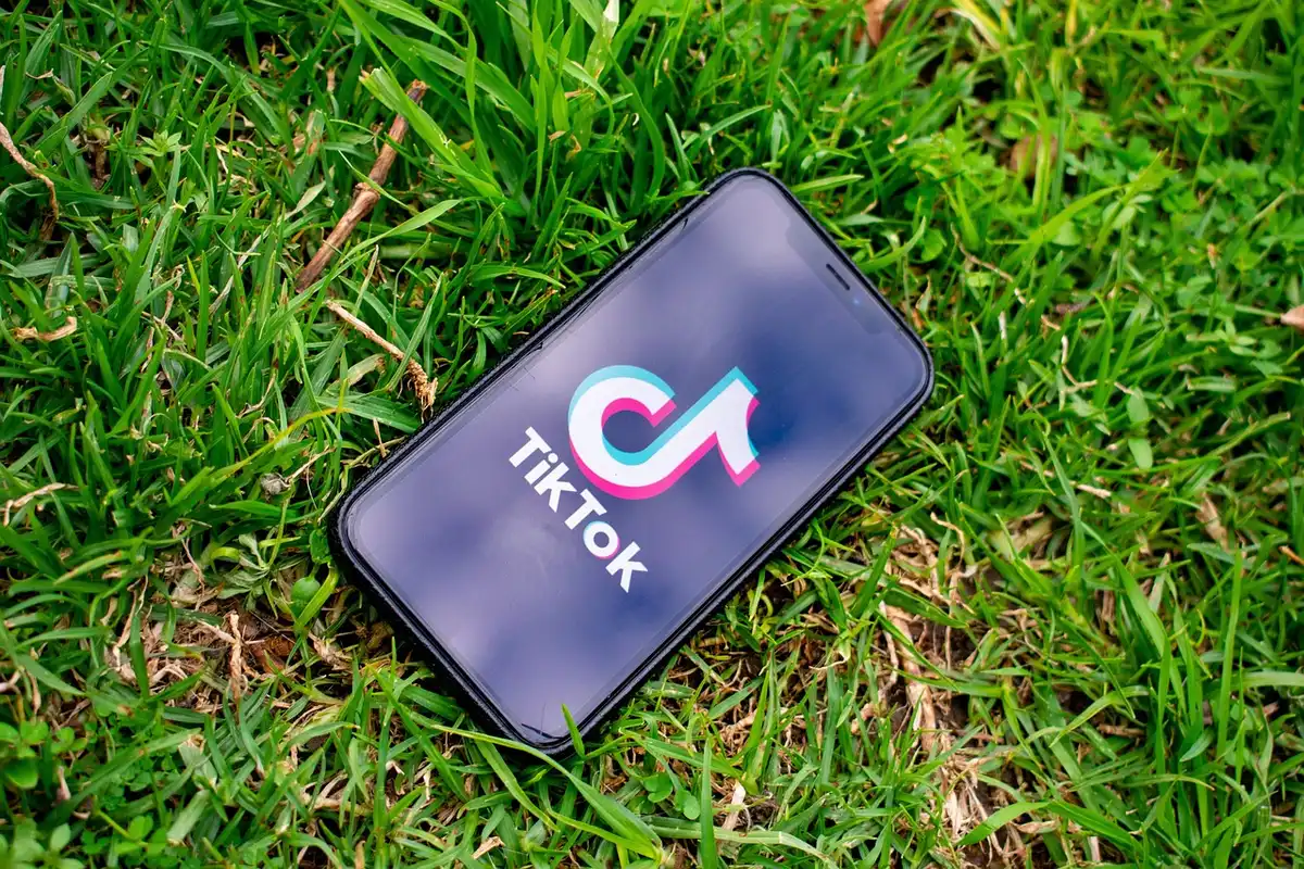 Close-up of a phone showing social media comments and notifications