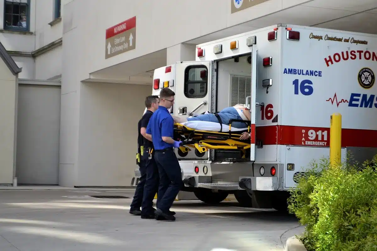 Paramedics attending to an injured person on a stretcher at a festival