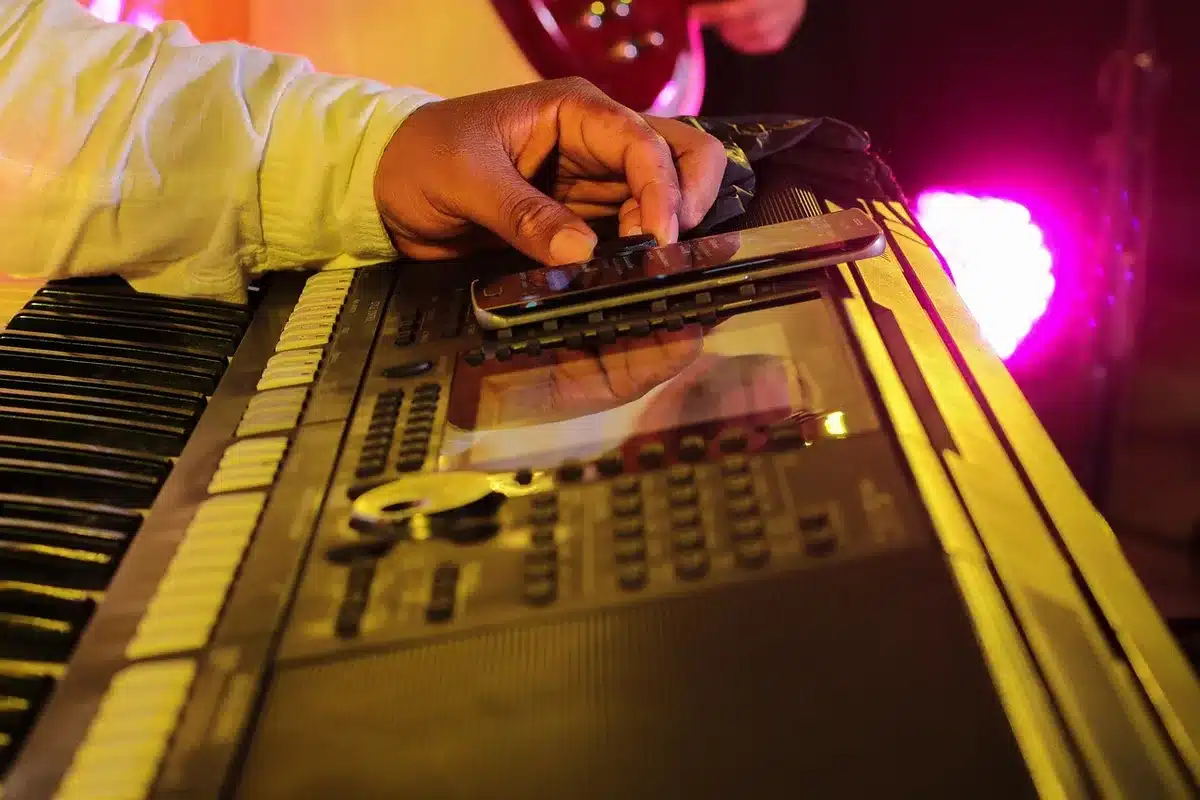 Producers around a mixing console during a collaborative session