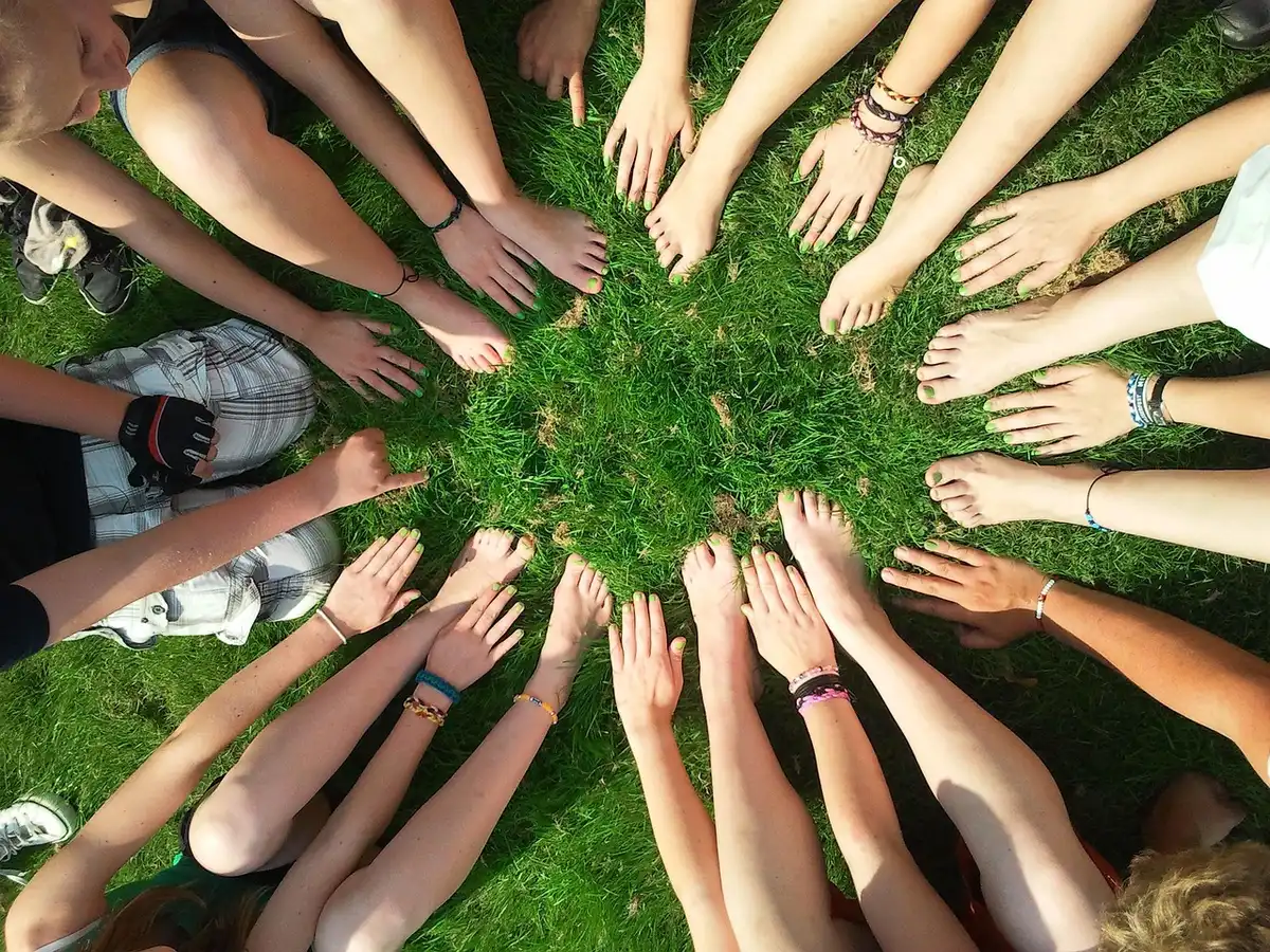 People sitting in a circle during a support meeting, symbolizing shared recovery and honesty