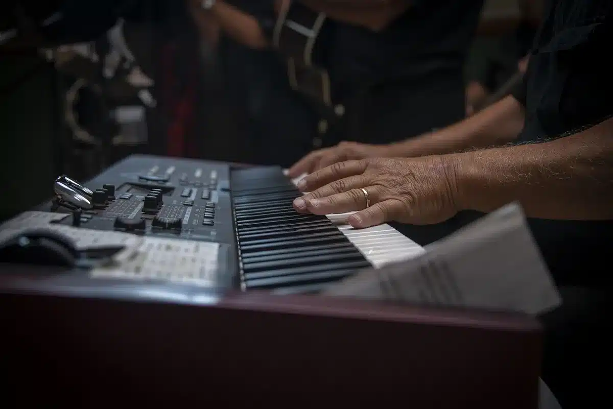 Guitarist jamming in a rehearsal space, hands on fretboard during riff development