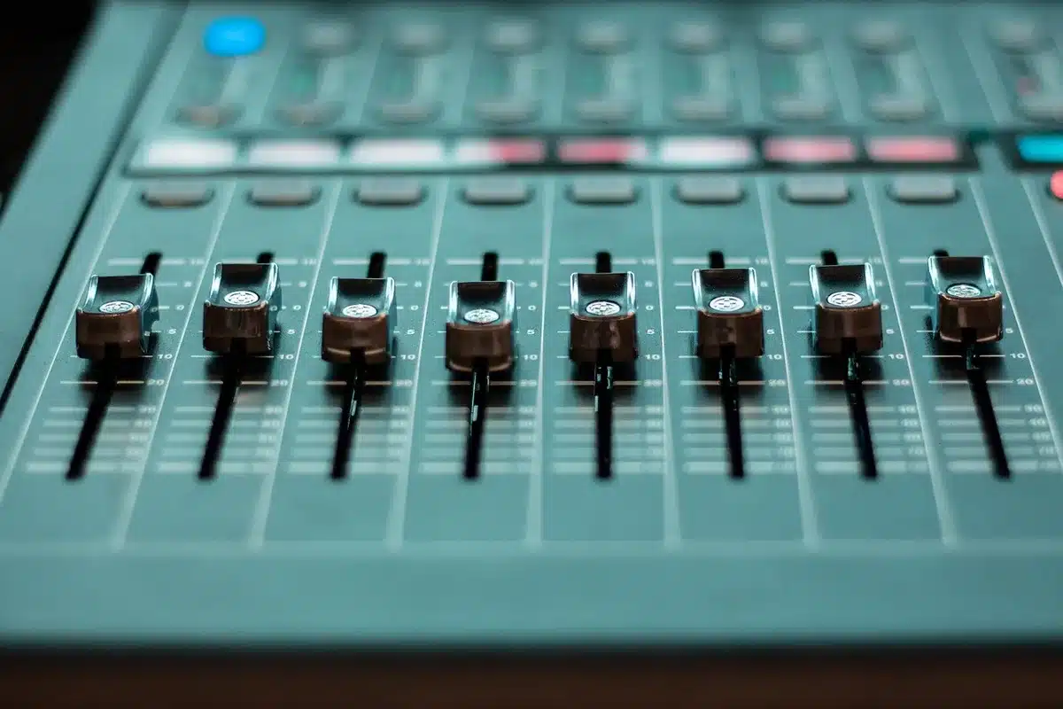 Drum kit and mixing console in a recording studio showing production setup