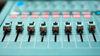 Mixing console with bass cable and handwritten music notes in a studio