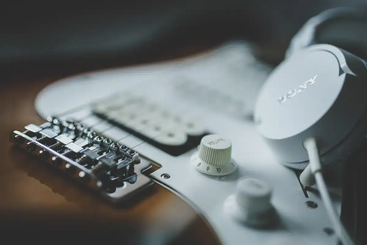 Producer at a dim studio desk with headphones and mixing gear