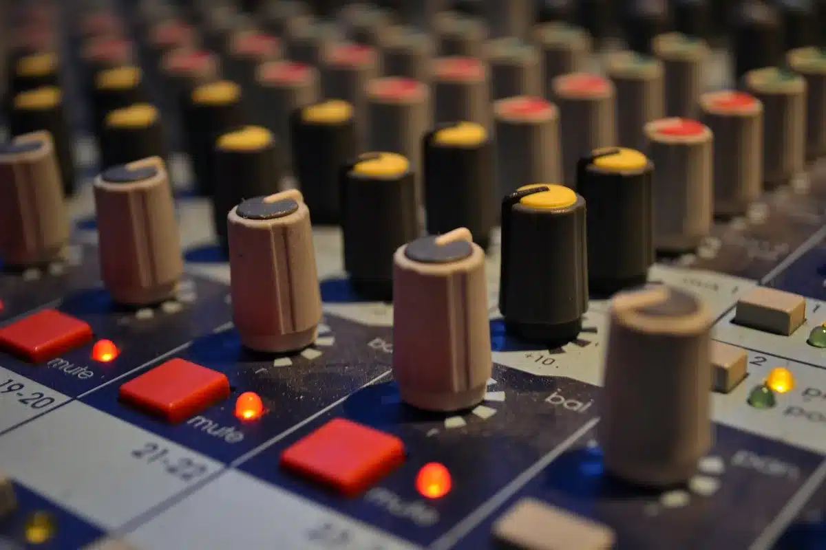 Producer working at mixing board in recording studio
