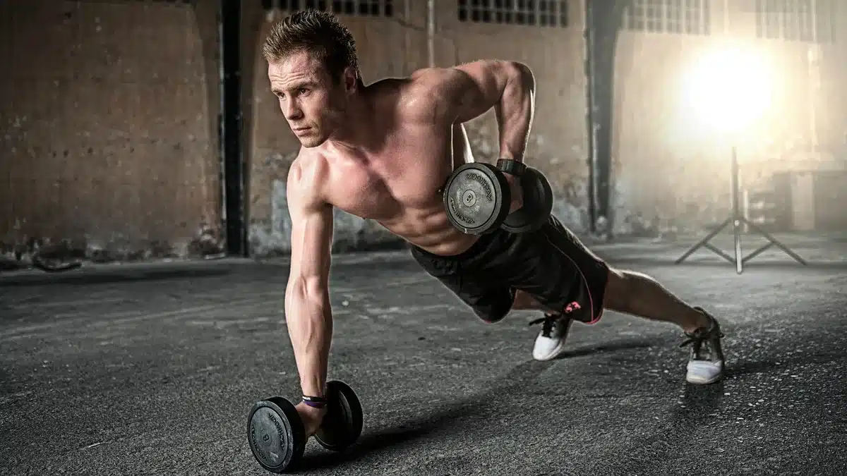 Weightlifter performing a snatch lift from floor to overhead in one continuous motion