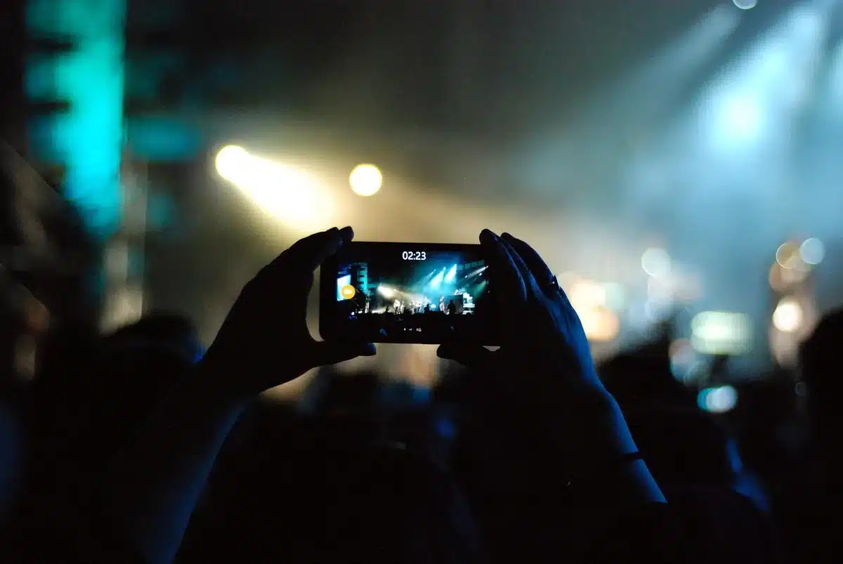 Festival crowd looking at phones and posting on social media